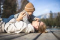 Happy family. Young mother playing with her baby boy infant oudoors on sunny autumn day. Portrait of mom and little son Royalty Free Stock Photo