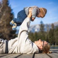 Happy family. Young mother playing with her baby boy infant oudoors on sunny autumn day. Portrait of mom and little son Royalty Free Stock Photo