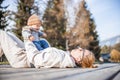 Happy family. Young mother playing with her baby boy infant oudoors on sunny autumn day. Portrait of mom and little son Royalty Free Stock Photo