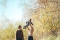 Happy family. Young mother throws up baby in the sky, on sunny autumn day Royalty Free Stock Photo