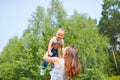 Happy family. Young mother throws up baby in the sky, on sunny day. Positive human emotions, feelings, joy Royalty Free Stock Photo