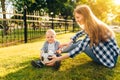 Happy family, young mother with toddler playing ball in the park Royalty Free Stock Photo