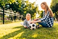 Happy family, young mother with toddler playing ball in the park Royalty Free Stock Photo