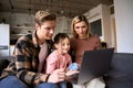 Happy family young parents and child daughter using laptop computer at home. Royalty Free Stock Photo