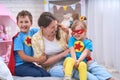 Happy family. A young woman plays with her children in superheroes Royalty Free Stock Photo