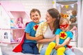 Happy family. A young woman plays with her children in superheroes Royalty Free Stock Photo