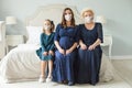 Happy familyin protective mask at home. Senior woman, pregnant adult woman and child girl. Mother, daughter, grandmother