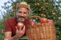 Happy Farmer With A Basket of Appetizing Red Apples Looking at Camera Royalty Free Stock Photo