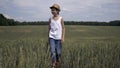 Happy farmer boy in a hat is walking across the field, outdoors Royalty Free Stock Photo