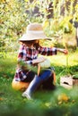 Happy farmer child girl with autumn harvest - organic pumpkins, carrots and zucchini picked from own garden Royalty Free Stock Photo