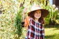 Happy farmer child girl picking fresh home growth carrot harvest Royalty Free Stock Photo