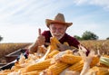 Happy farmer with corn cobs in trailer during harvest Royalty Free Stock Photo