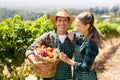 Happy farmer couple holding a basket of vegetables Royalty Free Stock Photo