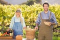 Happy farmer couple presenting their local food Royalty Free Stock Photo