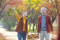 Happy farmer family carrying organics homegrown produce harvest with apple, squash and pumpkin while walking along country road Royalty Free Stock Photo