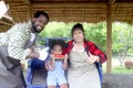 Happy farmer family work together in agriculture, mother and father gardener spend time with daughter kid, African Asian mixed Royalty Free Stock Photo