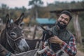 A happy farmer holding a cute goatling