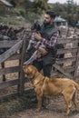 A happy farmer holding a cute goatling