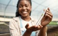 Happy farmer holding a plant sample. Young botanist holding a test tube sample. Young farmer collecting a sample of Royalty Free Stock Photo