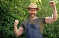 Happy farmer man in farmers hat and apron make winning gesture in garden aoutdoors Royalty Free Stock Photo