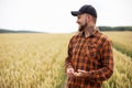 Happy farmer smiling on wheat field. Harvest time Royalty Free Stock Photo