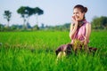 Happy farmer woman sitting in rice filed, Thailand Royalty Free Stock Photo