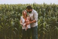 Happy farmers family parents with infant baby outdoor