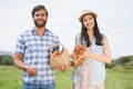 Happy farmers holding chicken and eggs Royalty Free Stock Photo