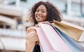 Happy, fashion and black woman shopping in a city for retail sale deals, promotions on clothes and discounts on bags Royalty Free Stock Photo