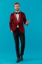 Happy fashion man wearing red velvet tuxedo Royalty Free Stock Photo