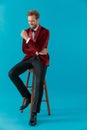 Happy fashion man wearing red velvet tuxedo and smiling Royalty Free Stock Photo