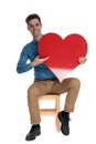 Happy fashion model holding big red heart and smiling Royalty Free Stock Photo