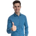 Happy fashion model smiling and making thumbs up sign Royalty Free Stock Photo