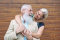 Happy fashion seniors couple embracing outdoor - Mature elegant people laughing and having a tender moment together