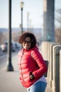 Happy fashionable woman along the city streets in red jacket Royalty Free Stock Photo