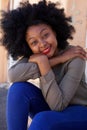 Happy fashionable woman sitting outside Royalty Free Stock Photo