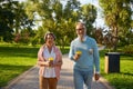 Happy fashioned elderly couple having coffee break walking in park Royalty Free Stock Photo