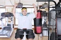 Happy fat man doing a workout with exercise bike Royalty Free Stock Photo