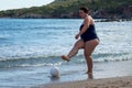 Happy fat woman playing ball on the beach Royalty Free Stock Photo