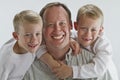 Happy father with 6 years old identical twins Royalty Free Stock Photo