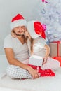 Happy Father and Baby with Christmas Gift near the Christmas Tree at home. Child opening a Gift Box Royalty Free Stock Photo