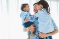 Happy father carrying two children in bedroom at home. Asian family living and having facial expression togetherness. Leisure time