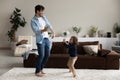 Happy father with cute little son dancing in living room Royalty Free Stock Photo