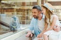 happy father and daughter looking at monkey while sitting near window in zoo. Royalty Free Stock Photo