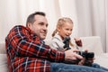 happy father and daughter playing with joysticks Royalty Free Stock Photo