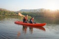 Father and daughter rowing boat on calm waters