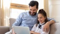 Happy father with daughter using laptop together at home Royalty Free Stock Photo