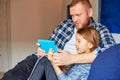 Happy father with daughter using tablet computer in living room, at sofa at home Royalty Free Stock Photo