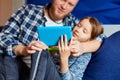 Happy father with daughter using tablet computer in living room, at sofa at home Royalty Free Stock Photo