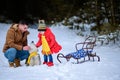 Happy father with daughter on a walk in the woods, girl and husky in yellow scarves, bright clothes in winter. Royalty Free Stock Photo